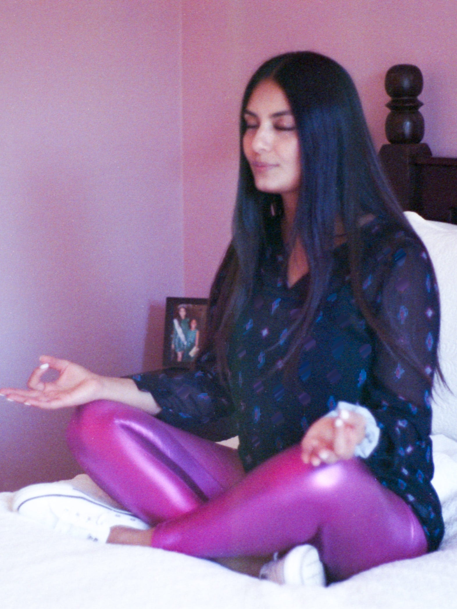 Brenda Sarai Zuniga sitting on her bed, meditating