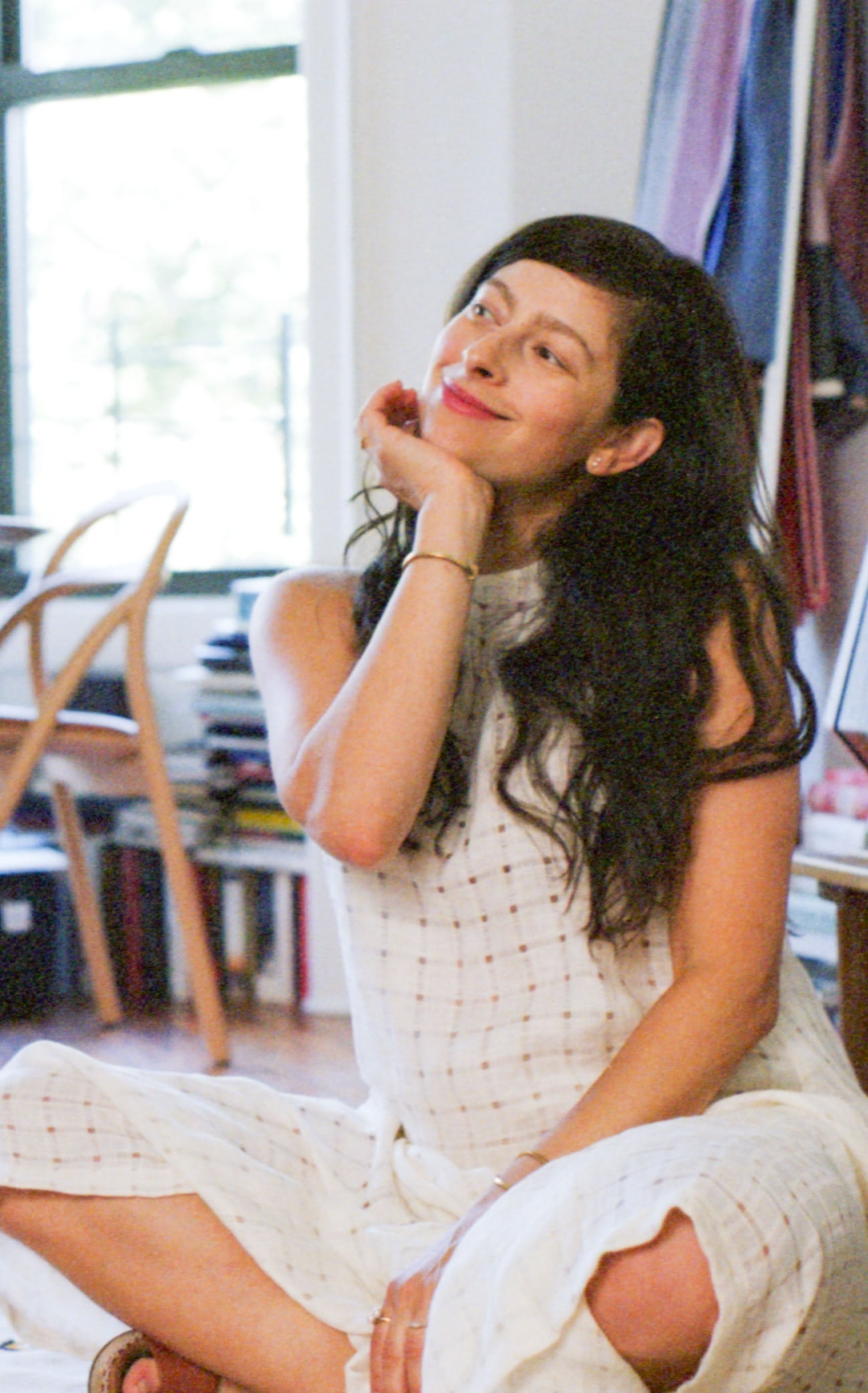 Erin Allweiss sitting in her living room, smiling